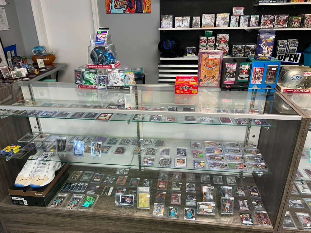Glass case filled with graded slabs, autographed cards and signed sneakers